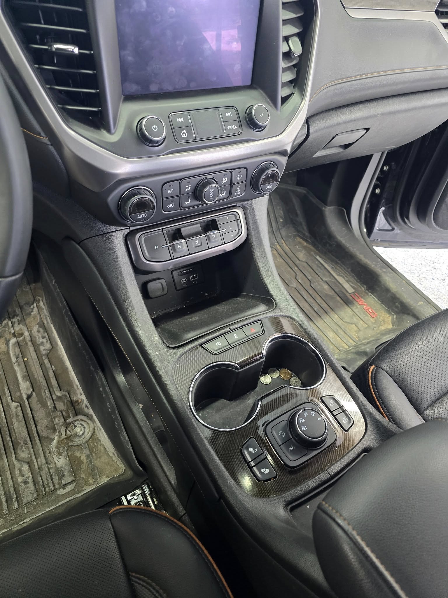 GMC Acadia cupholders — BEFORE (debris & dust)